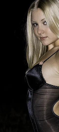 blonde girl in lingerie looks over her shoulder